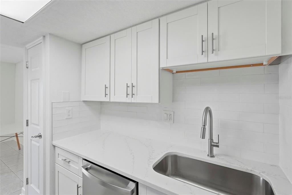 8921 Blind Pass Road, Unit 144 St. Pete Beach, FL 33706 - Photo 6 of 37 a close view of a sink and cabinets in kitchen