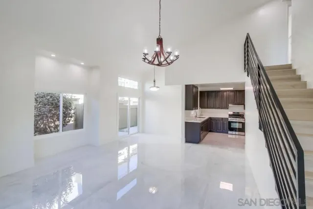 a lobby with furniture and chandelier