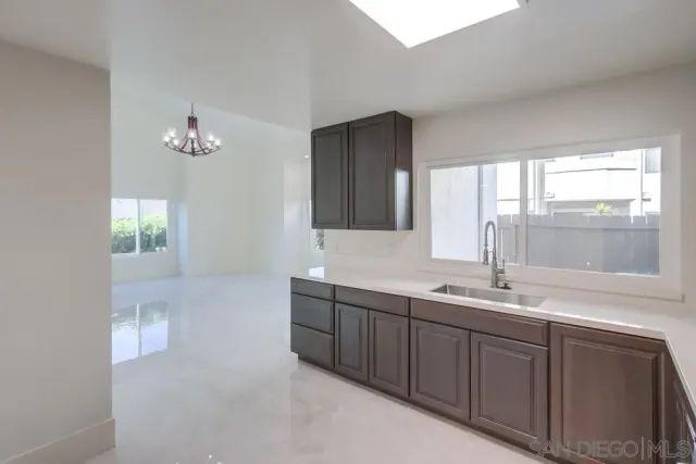 a bathroom with double vanity and a mirror