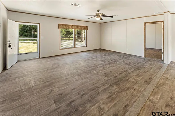 an empty room with windows and closet