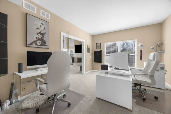 a view of a workspace with furniture and a flat screen tv