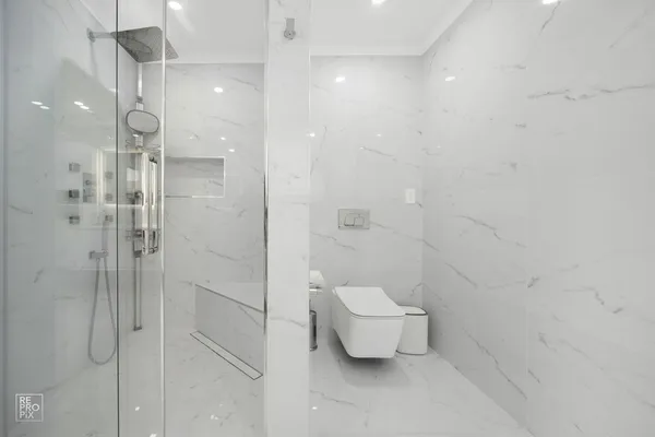 a bathroom with a toilet and a shower