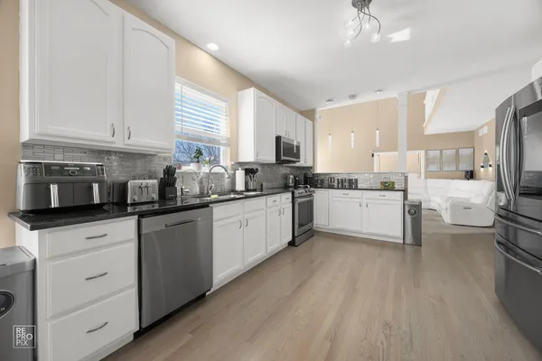 a kitchen with a white cabinets and white appliances