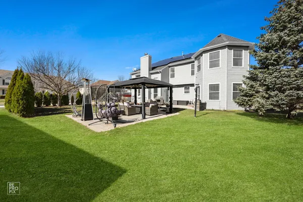 a view of a house with backyard and porch