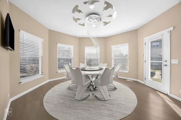a view of a dining room with furniture wooden floor and chandelier