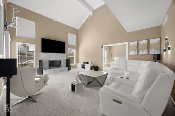 a living room with furniture a flat screen tv and a fireplace