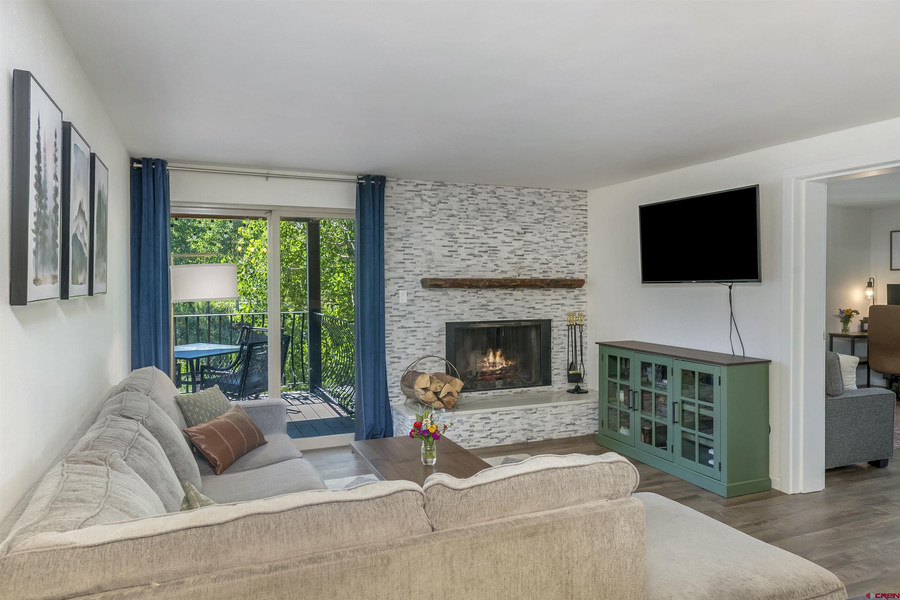 651 Gothic Road, Unit 511 Crested Butte, CO 81225 - Photo 11 of 34 a living room with furniture a flat screen tv and a fireplace