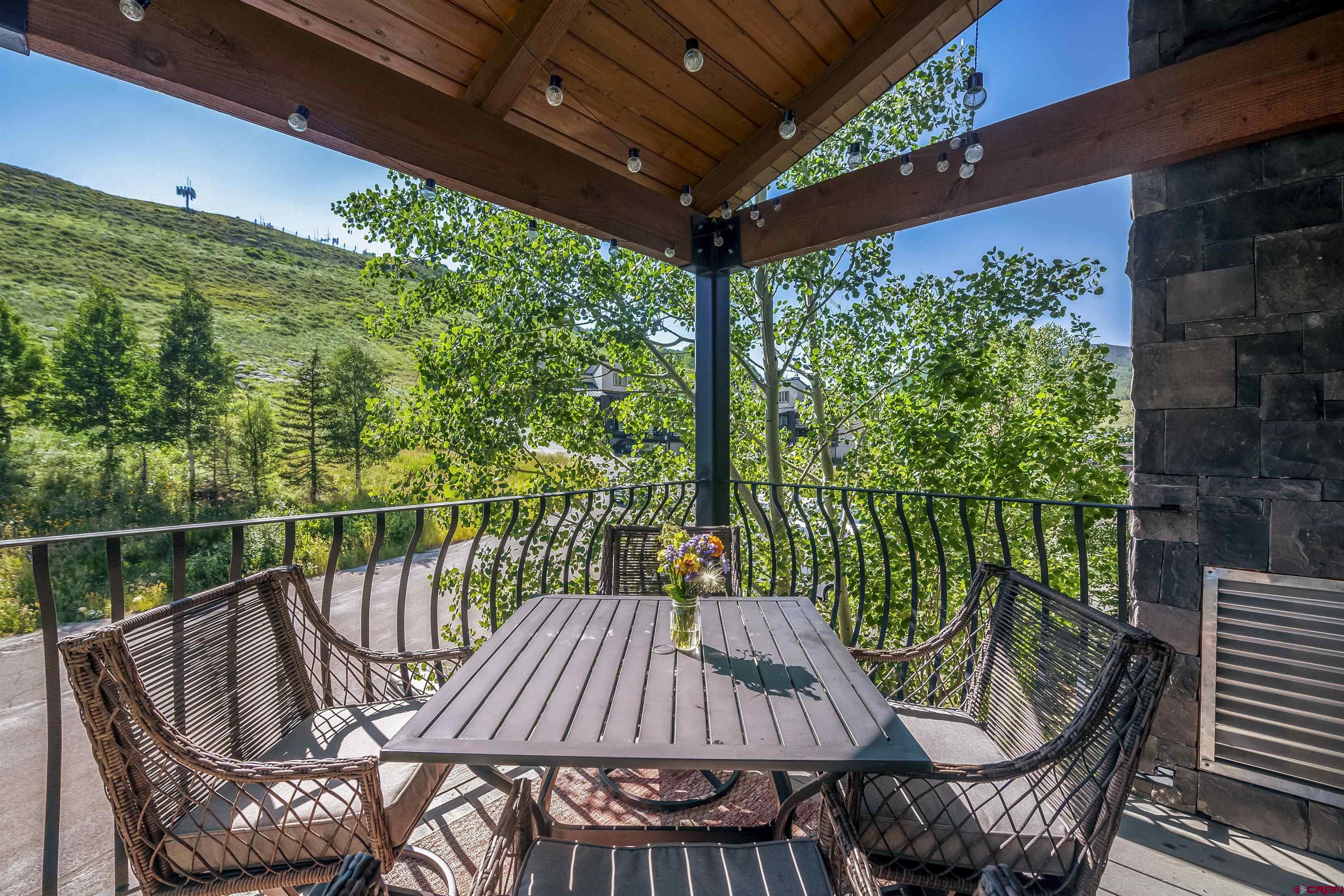 651 Gothic Road, Unit 511 Crested Butte, CO 81225 - Photo 13 of 34 a view of a patio with a table chairs and a backyard