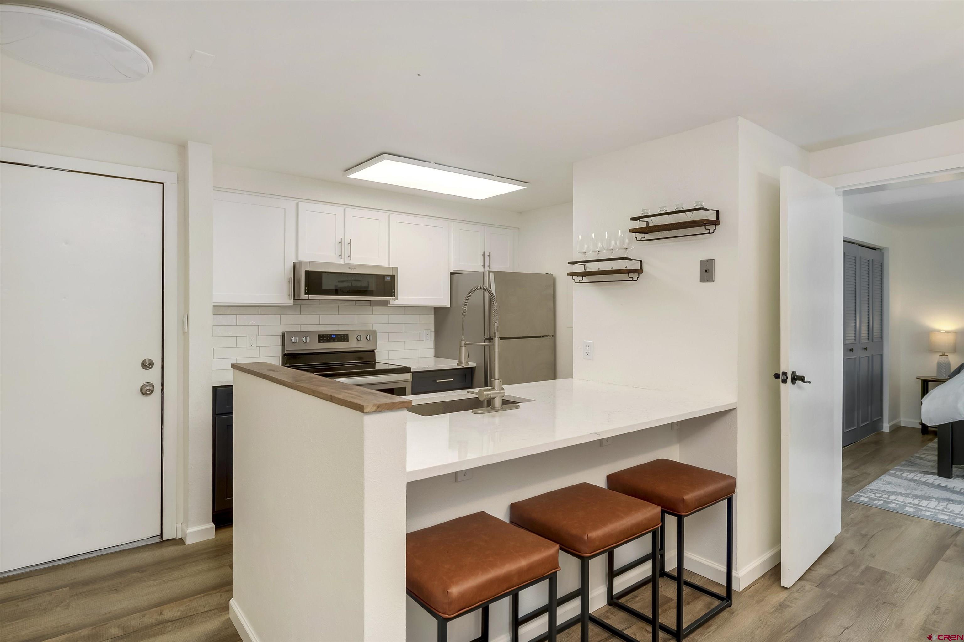 651 Gothic Road, Unit 511 Crested Butte, CO 81225 - Photo 18 of 34 a kitchen with stainless steel appliances a refrigerator and a stove top oven