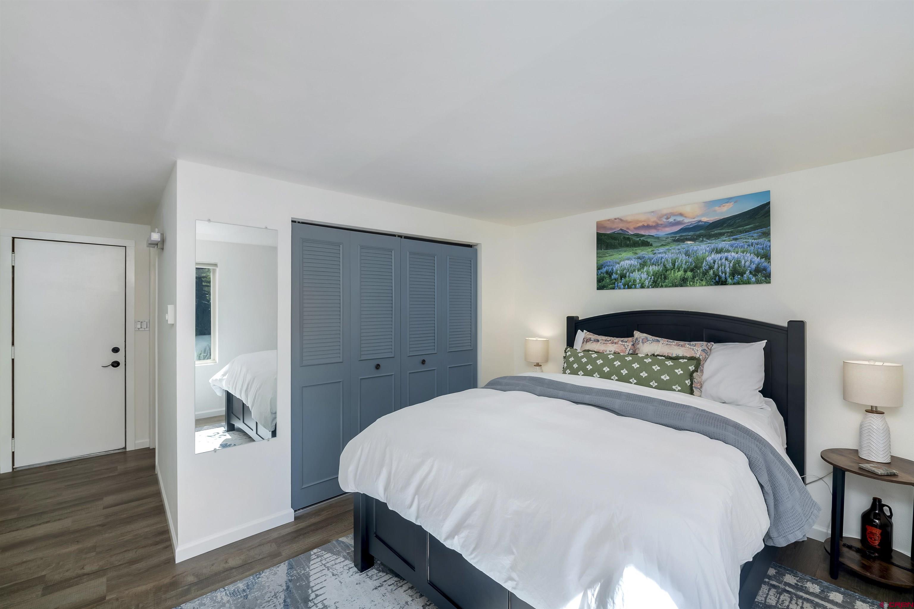 651 Gothic Road, Unit 511 Crested Butte, CO 81225 - Photo 20 of 34 a bedroom with a bed and a painting on the wall