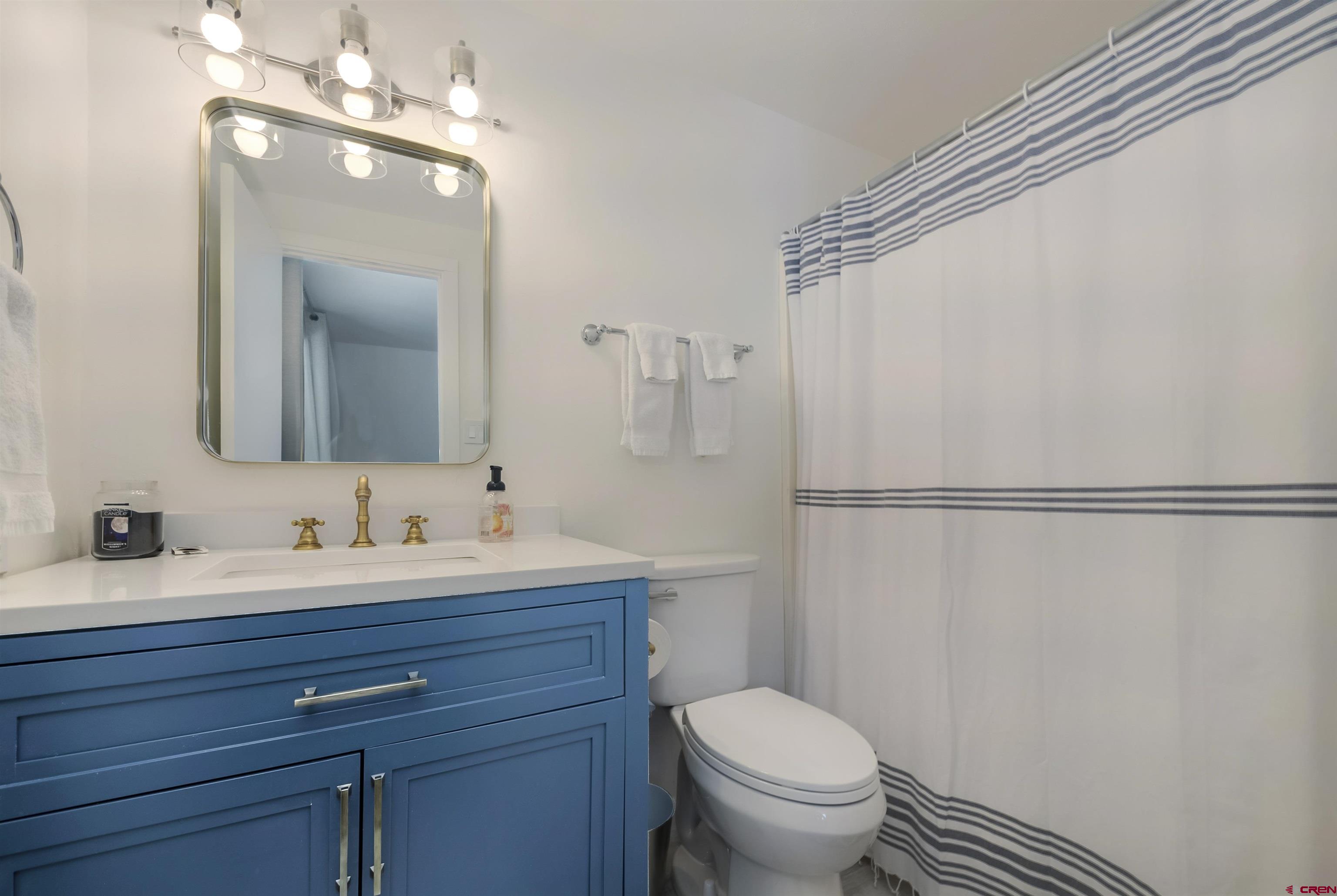 651 Gothic Road, Unit 511 Crested Butte, CO 81225 - Photo 25 of 34 a bathroom with a toilet a sink and a mirror