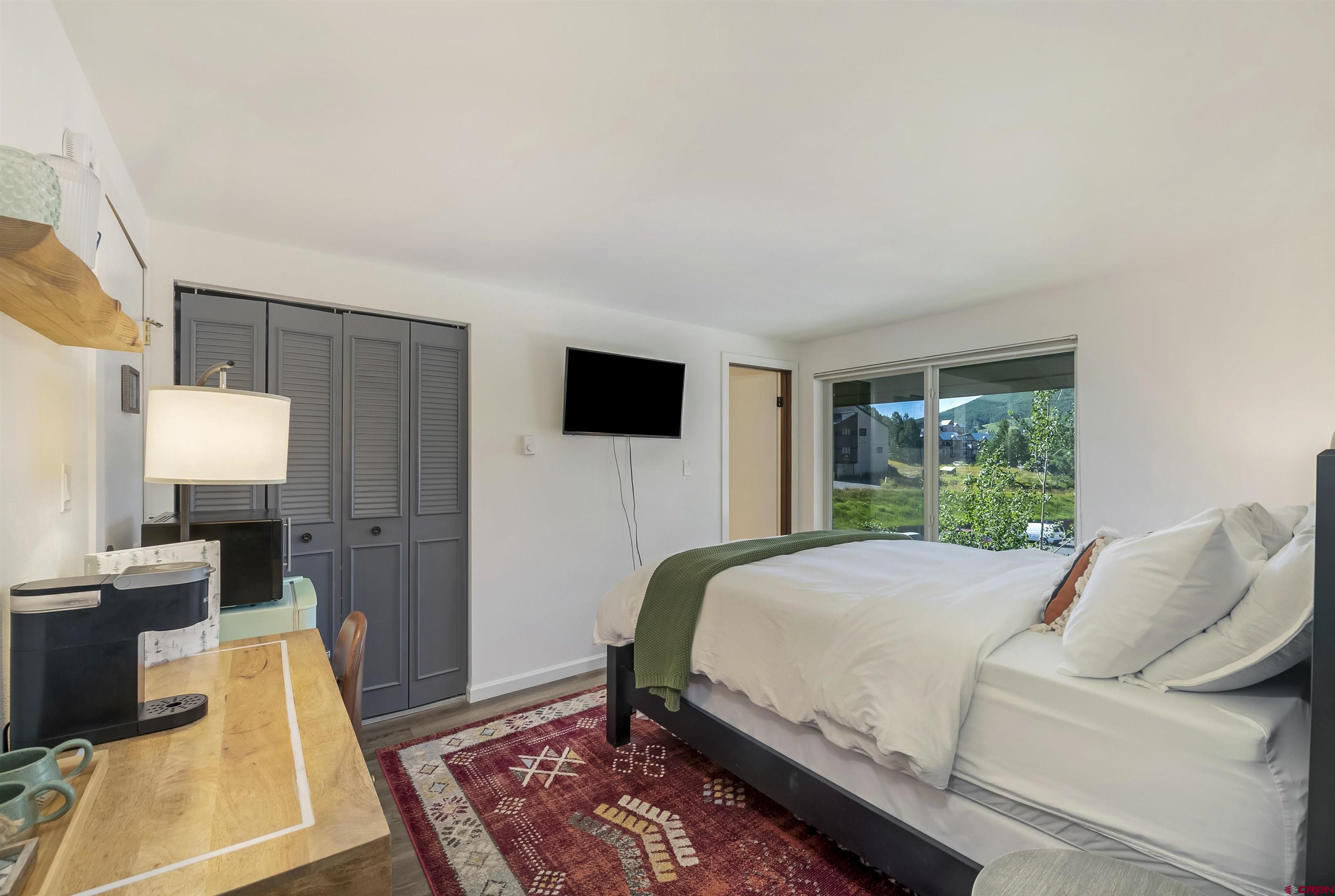 651 Gothic Road, Unit 511 Crested Butte, CO 81225 - Photo 26 of 34 a bed room with a bed a television and a couch