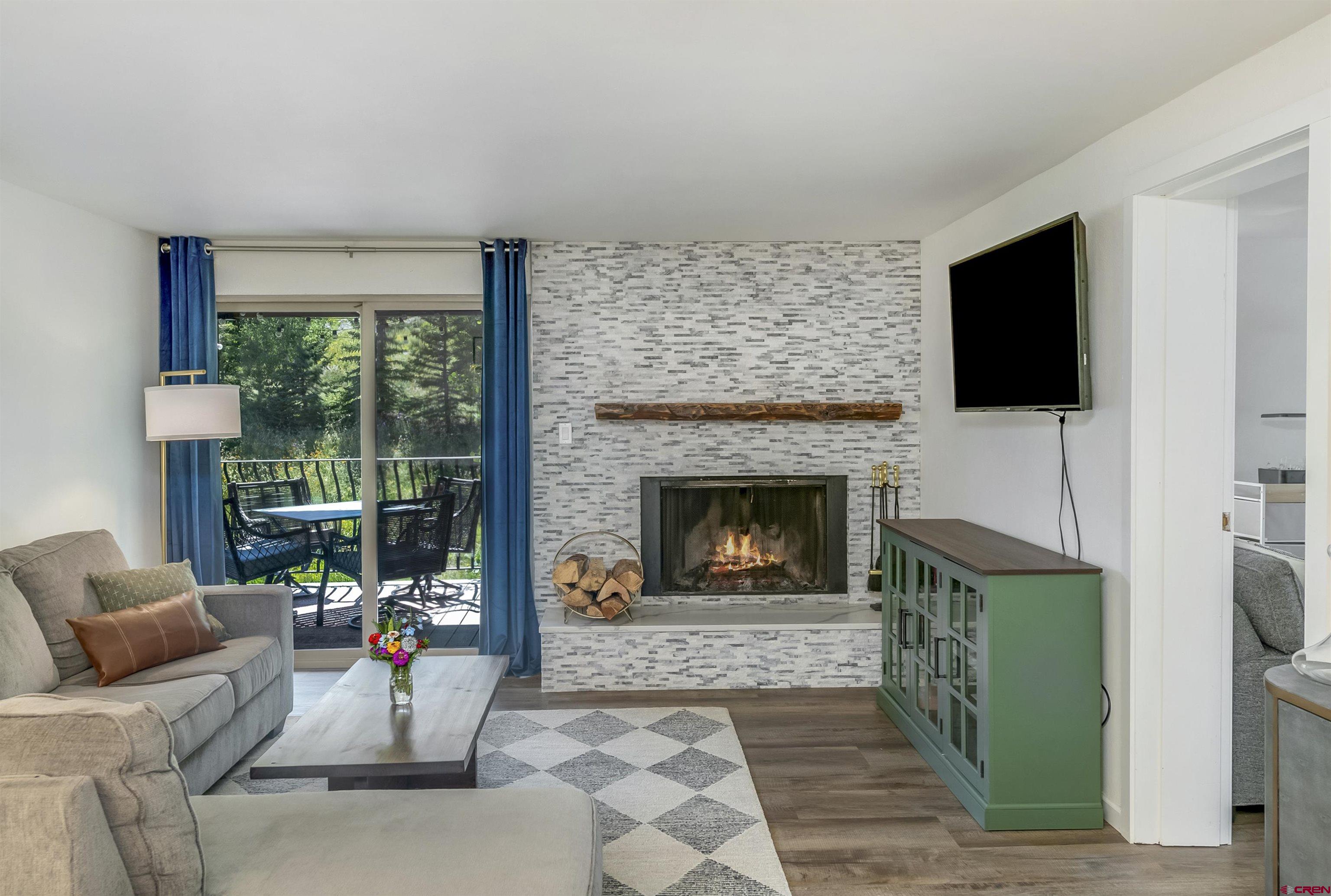 651 Gothic Road, Unit 511 Crested Butte, CO 81225 - Photo 10 of 34 a living room with furniture a flat screen tv and a fireplace