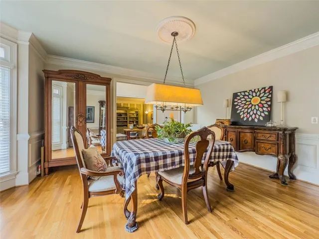 a bedroom with furniture and a chandelier fan
