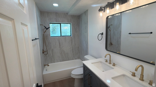 647 Swenson Avenue, Unit 4 Springville, UT 84663 - Photo 9 of 14 Full bathroom featuring double vanity, shower / bath combination, a textured ceiling, and dark wood-type flooring