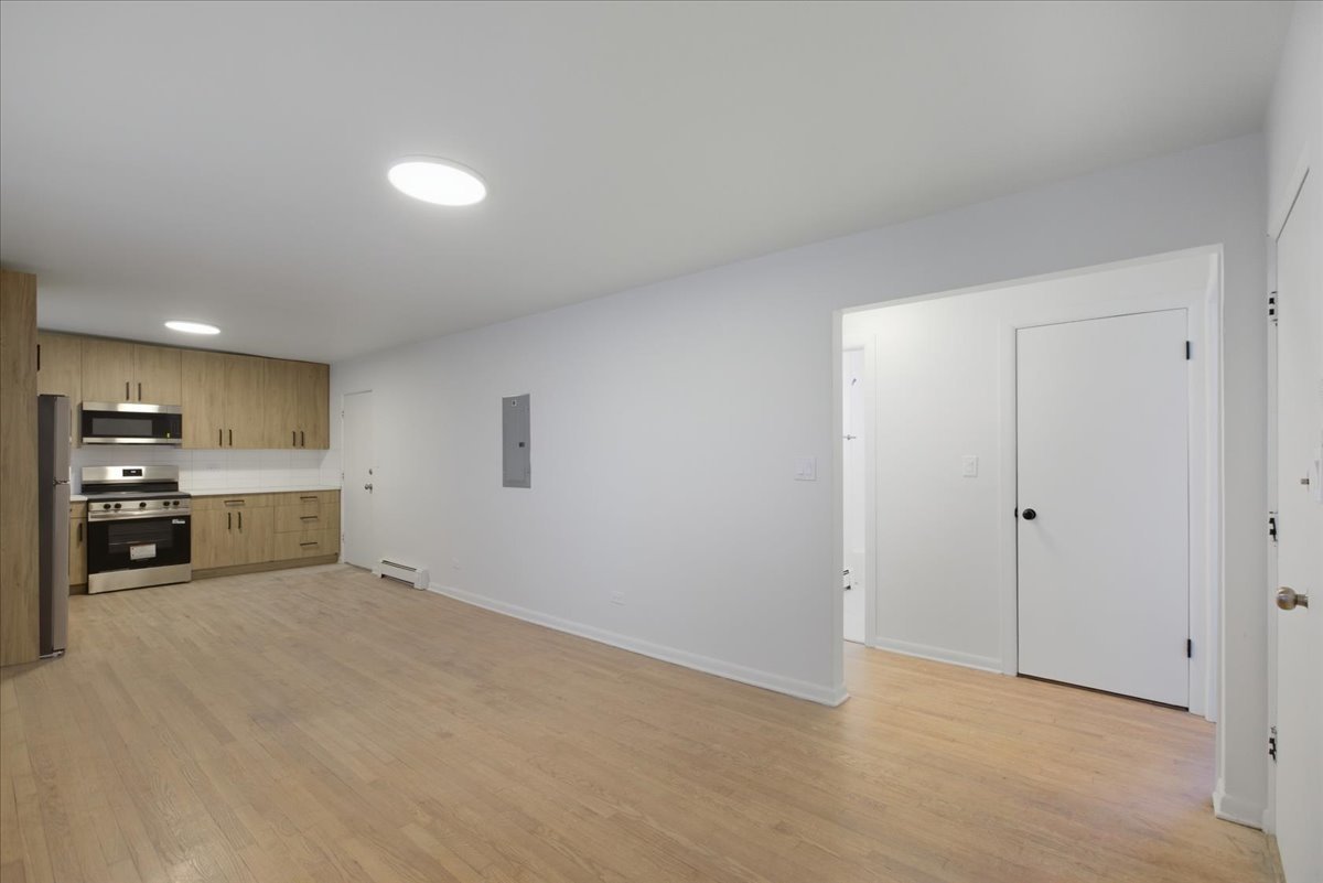 7357 North Winchester Avenue, Unit 2M Chicago, IL 60626 - Photo 5 of 10 a view of a kitchen with a sink and a refrigerator