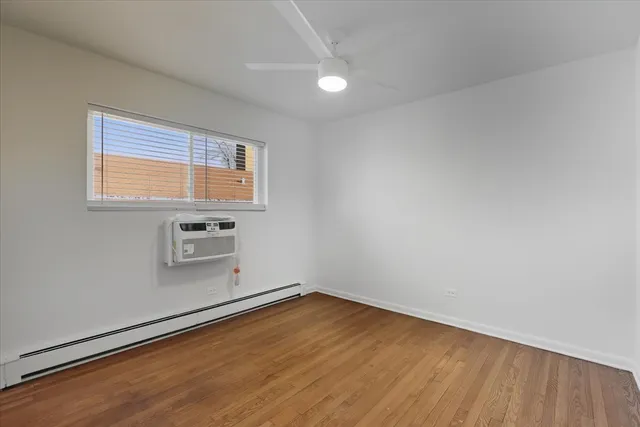a view of a room with wooden floor and white walls