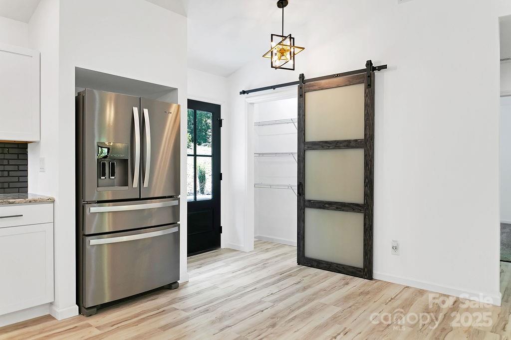 147 Wood Road Brevard, NC 28712 - Photo 12 of 24 a kitchen with stainless steel appliances a refrigerator and a hard wood floor