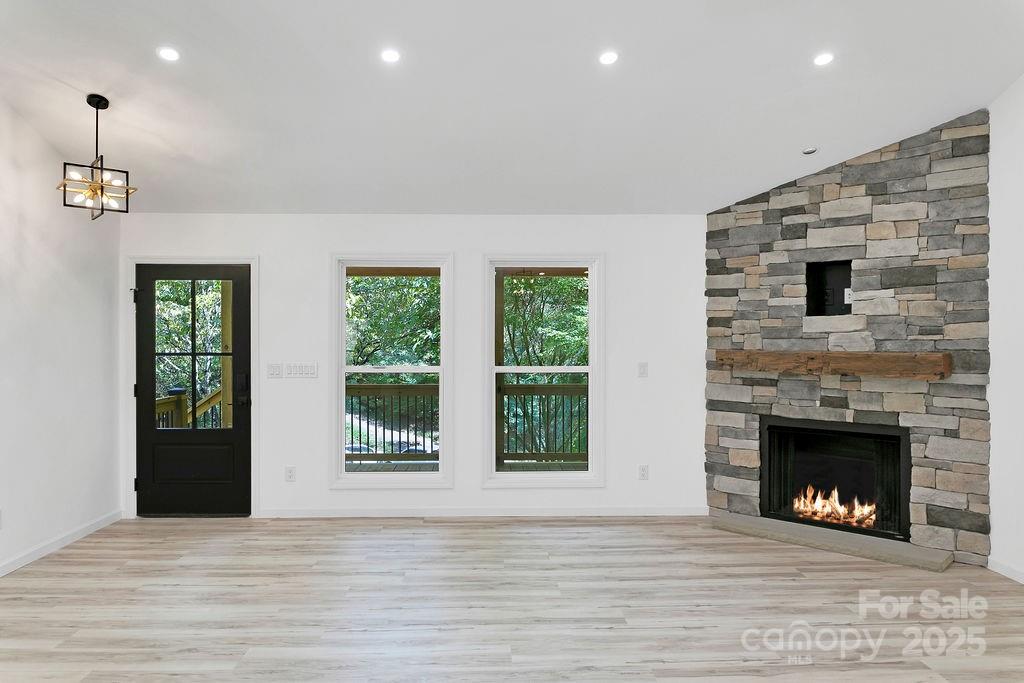 147 Wood Road Brevard, NC 28712 - Photo 9 of 24 a view of a livingroom with a fireplace and window