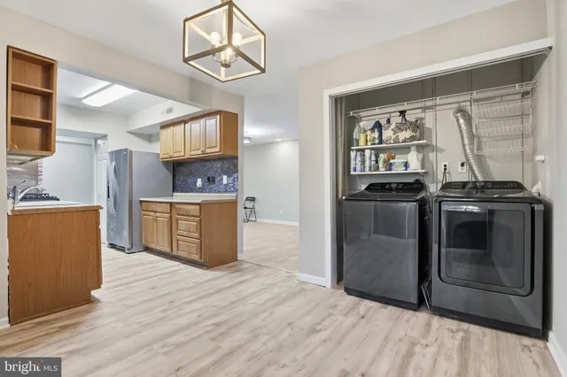 a kitchen with stainless steel appliances granite countertop a stove a refrigerator and a microwave