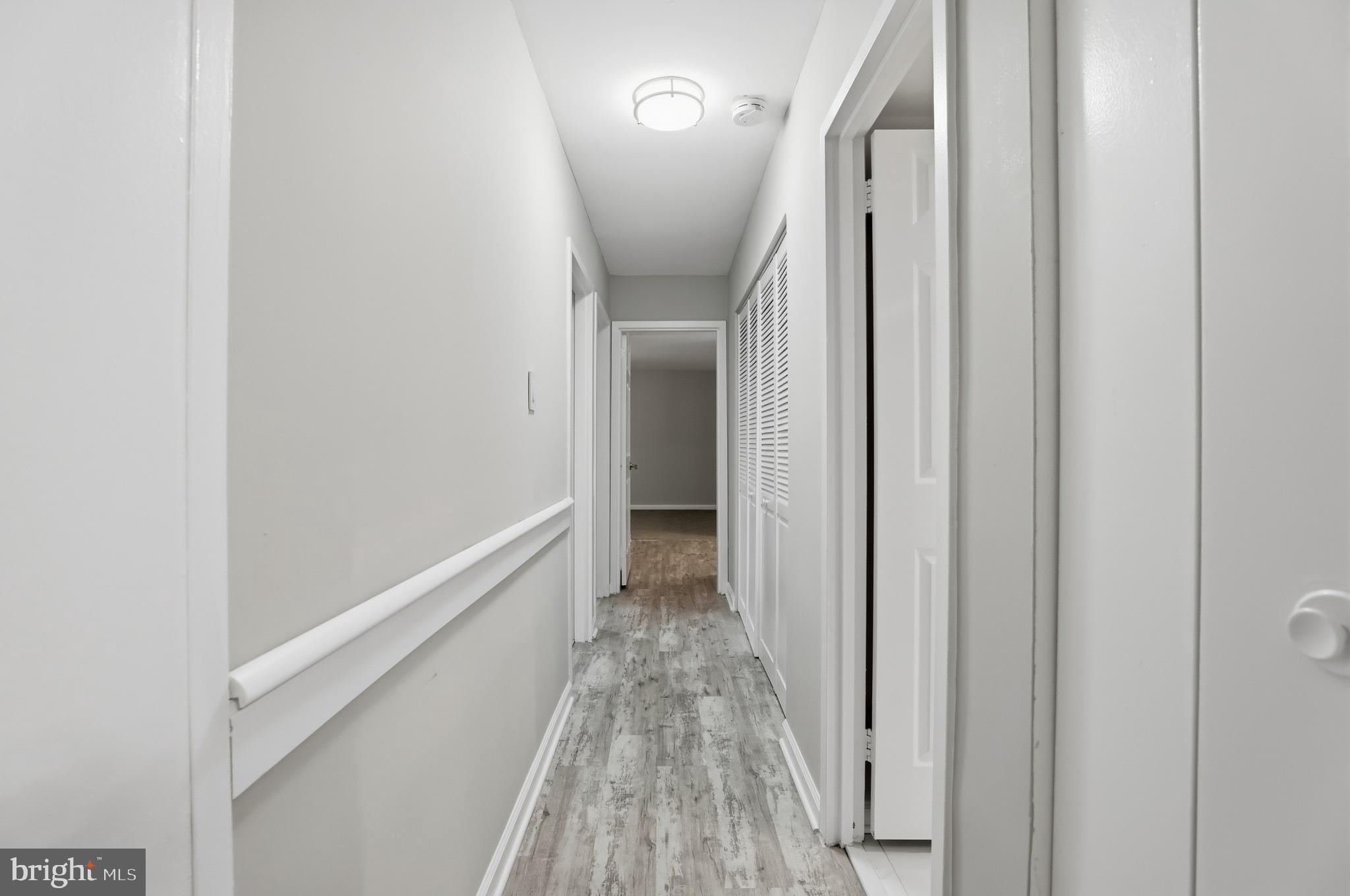 11242 Cherry Hill Road, Unit 1 Beltsville, MD 20705 - Photo 16 of 31 a view of a hallway with wooden floor