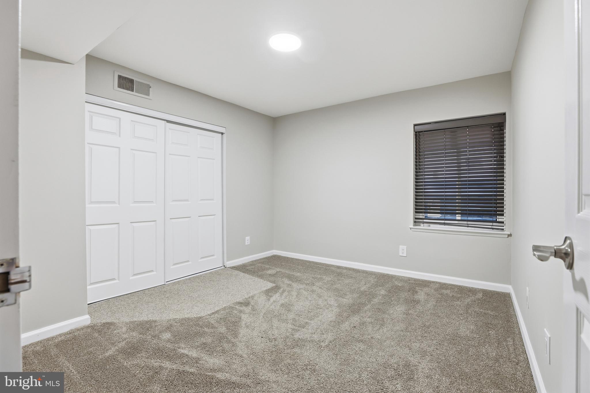 11242 Cherry Hill Road, Unit 1 Beltsville, MD 20705 - Photo 18 of 31 a view of an empty room with a window