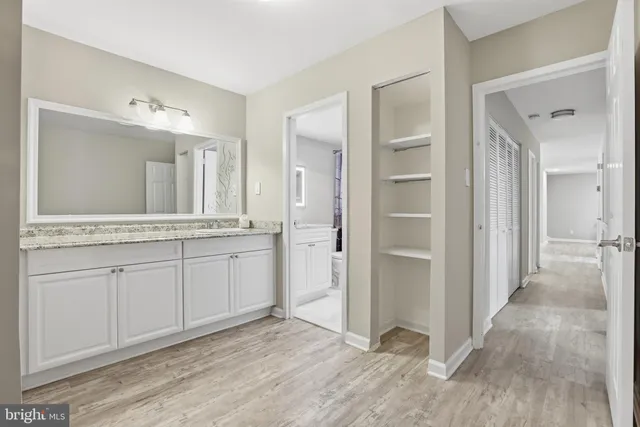 a bathroom with a granite countertop toilet sink and bathtub