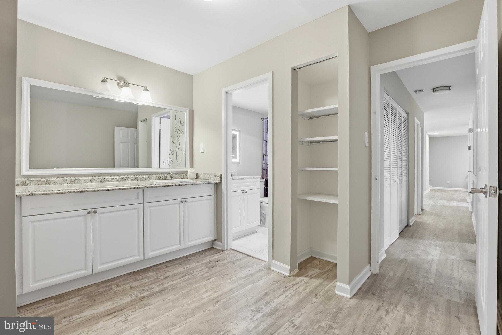 11242 Cherry Hill Road, Unit 1 Beltsville, MD 20705 - Photo 23 of 31 a spacious bathroom with a granite countertop sink mirror and a
