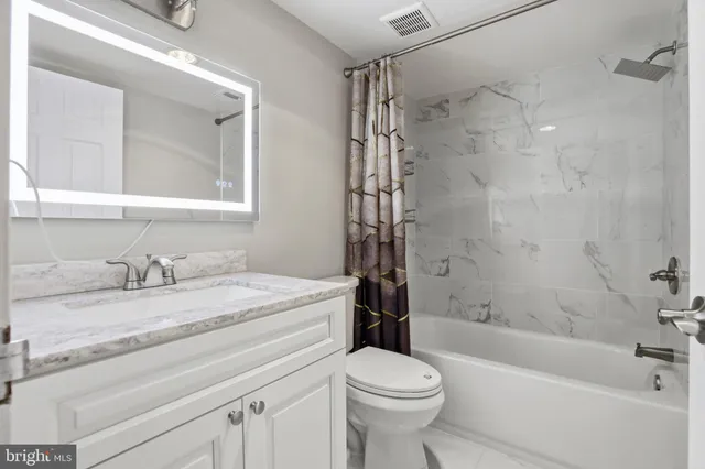 a view of an empty room and closet area