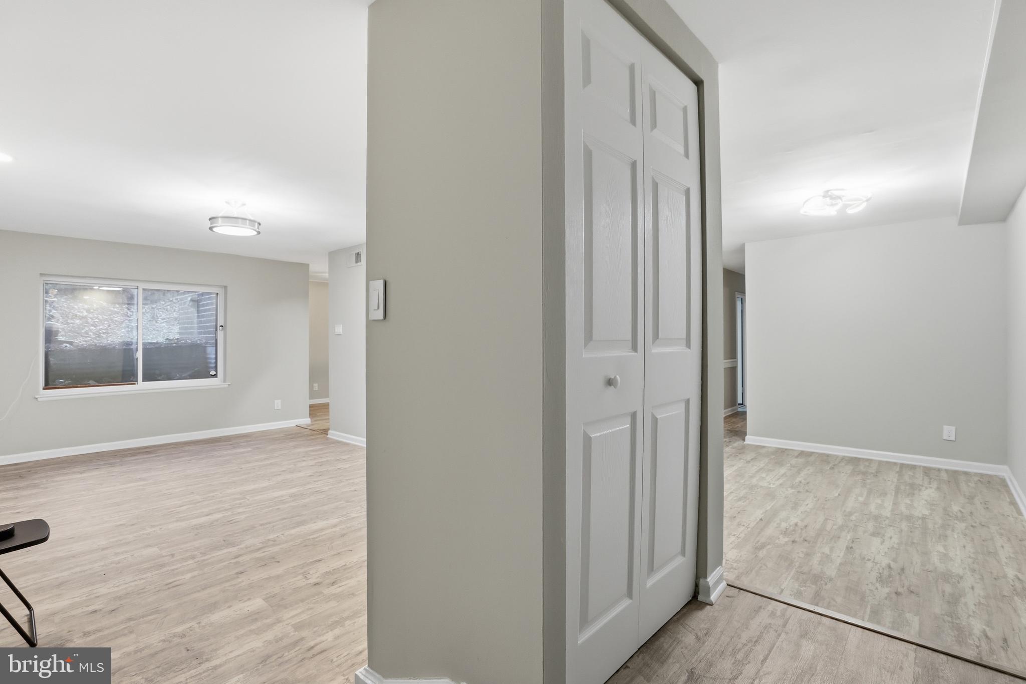 11242 Cherry Hill Road, Unit 1 Beltsville, MD 20705 - Photo 5 of 31 an empty room with wooden floor and a bathroom