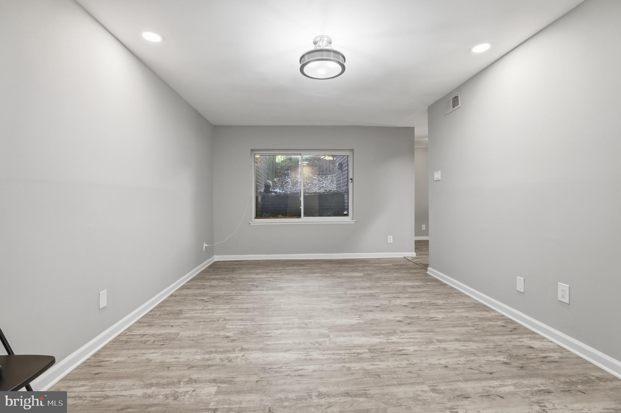11242 Cherry Hill Road, Unit 1 Beltsville, MD 20705 - Photo 6 of 31 wooden floor in an empty room with a window
