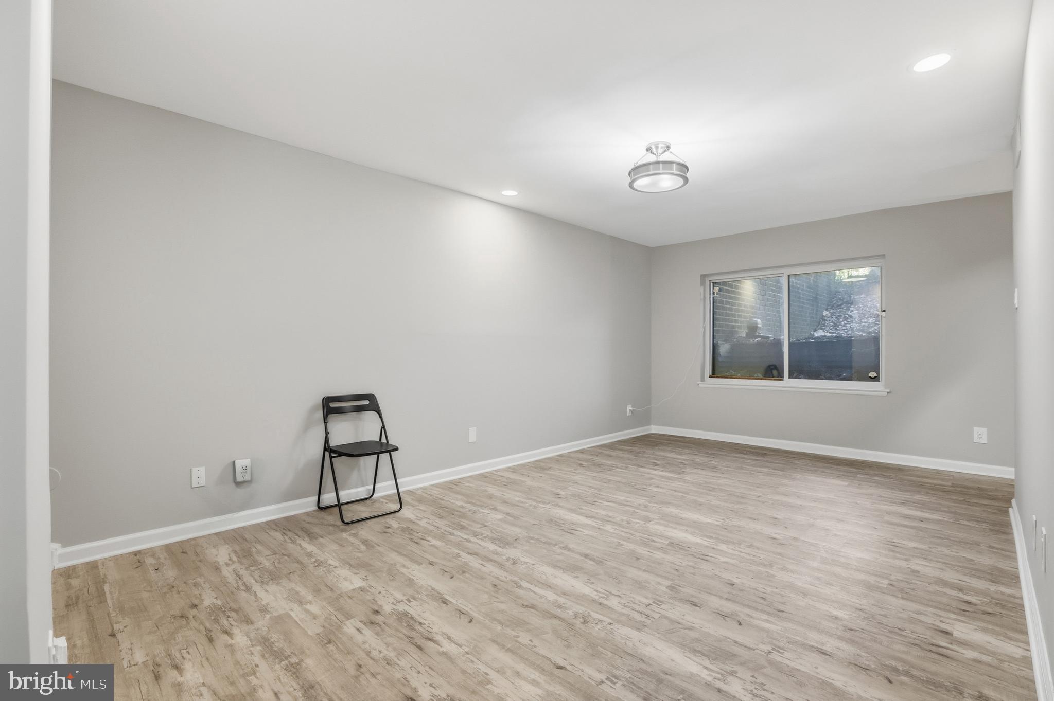 11242 Cherry Hill Road, Unit 1 Beltsville, MD 20705 - Photo 8 of 31 wooden floor in an empty room with a window