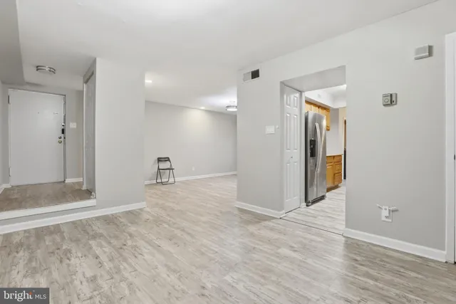 a view of a big room with wooden floor and a bathroom