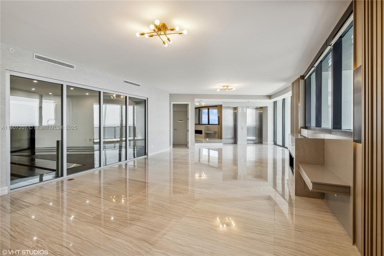 18555 Collins Avenue, Unit 1101 Sunny Isles Beach, FL 33160 - Photo 12 of 46 a view of an entryway with wooden floor and a livingroom view