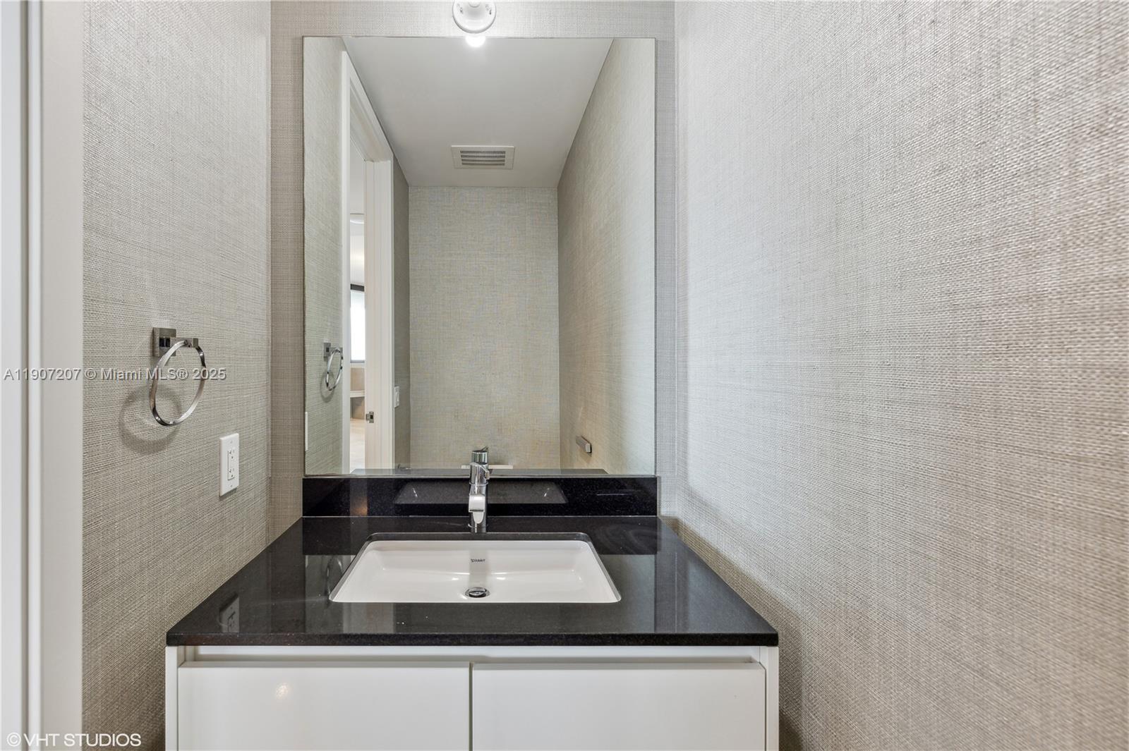 18555 Collins Avenue, Unit 1101 Sunny Isles Beach, FL 33160 - Photo 20 of 46 a bathroom with a sink and a mirror