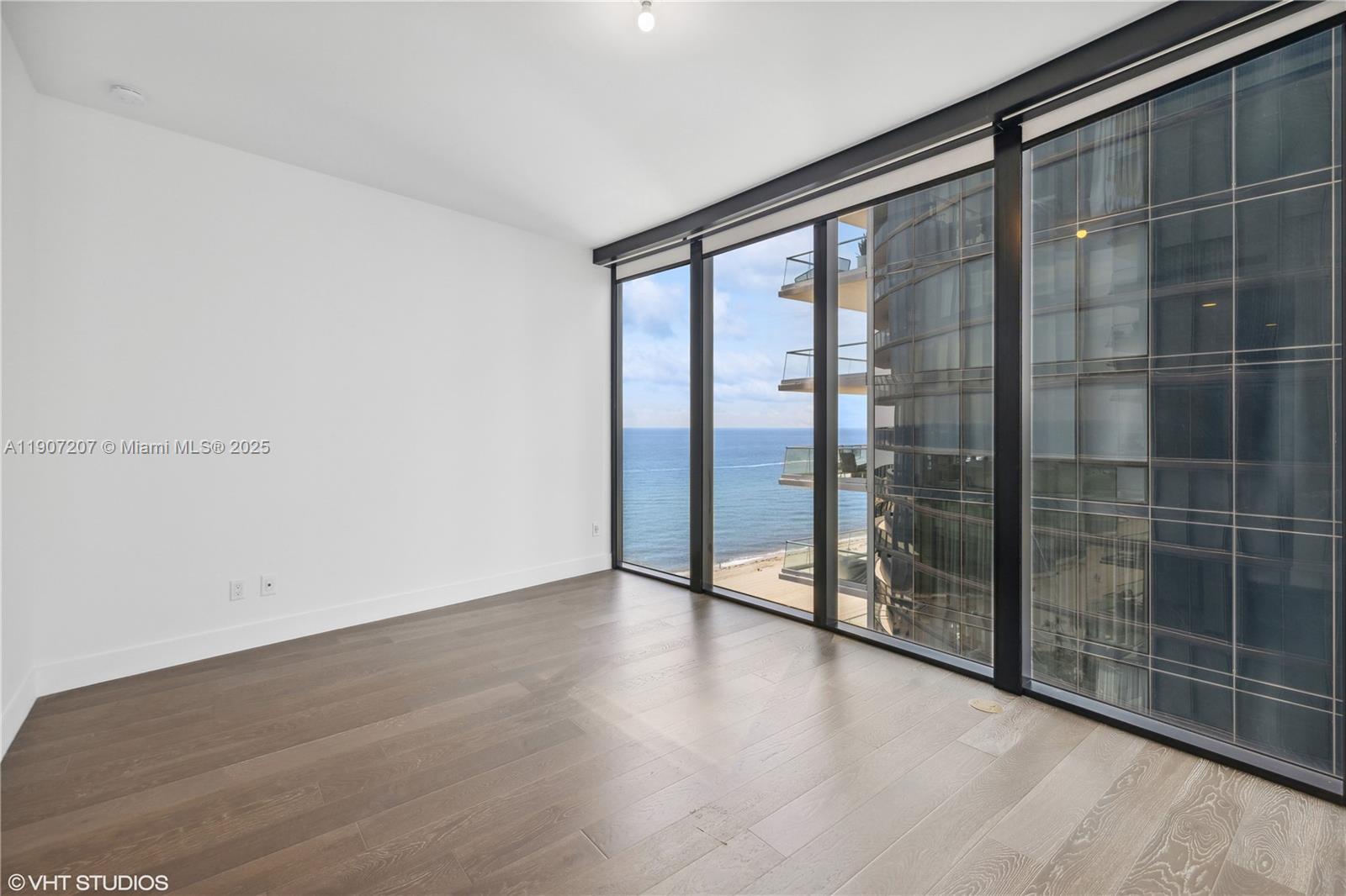 18555 Collins Avenue, Unit 1101 Sunny Isles Beach, FL 33160 - Photo 28 of 46 a view of an empty room with glass door