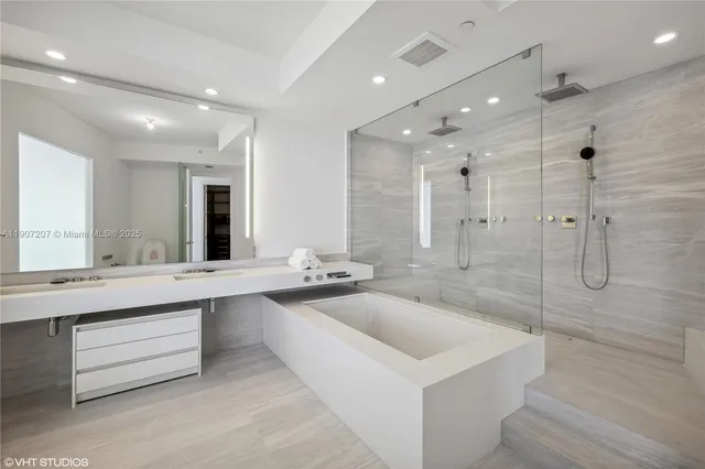 a spacious bathroom with a bathtub and a shower