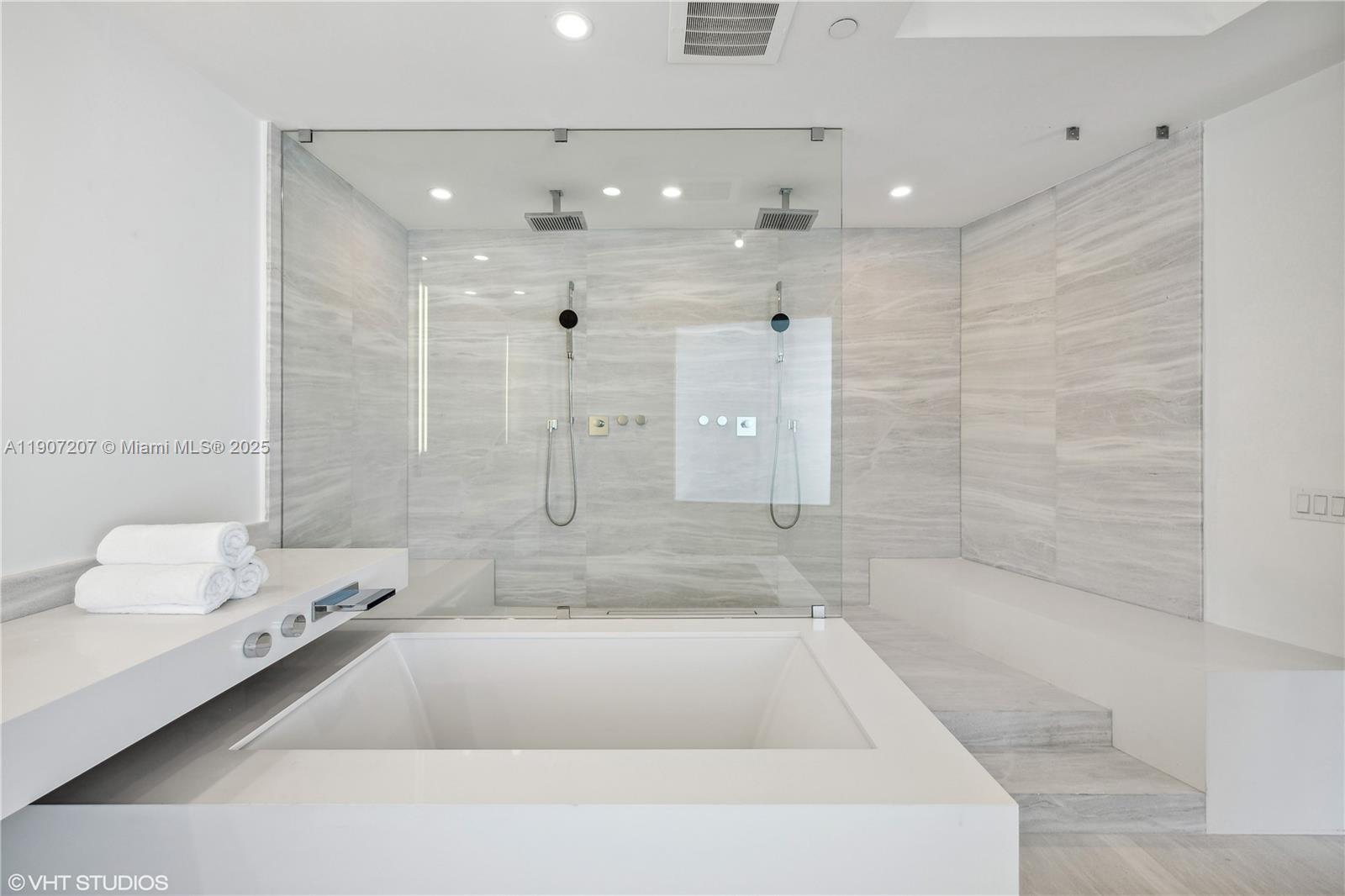 18555 Collins Avenue, Unit 1101 Sunny Isles Beach, FL 33160 - Photo 31 of 46 a spacious bathroom with a bathtub and a shower
