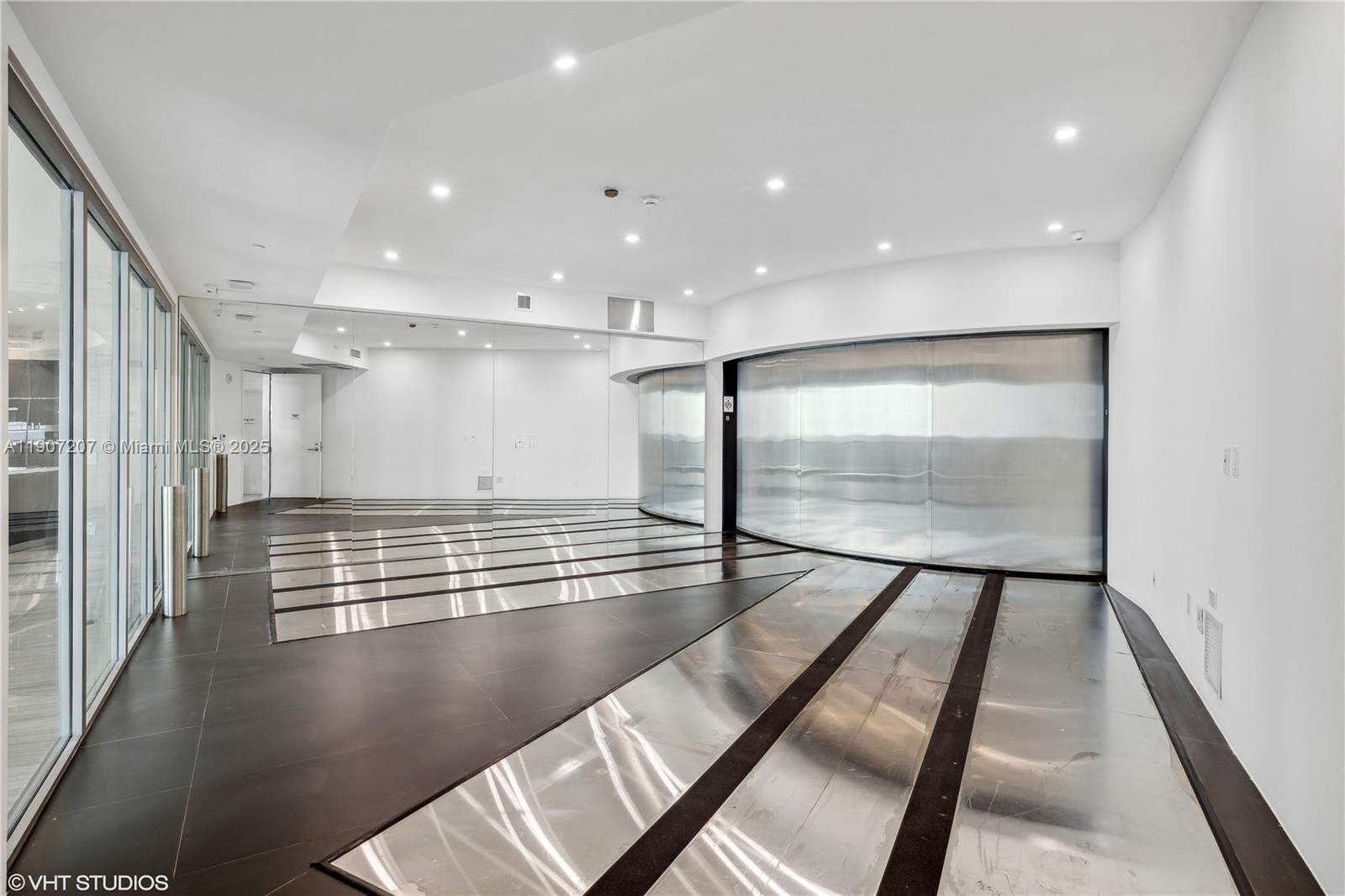 18555 Collins Avenue, Unit 1101 Sunny Isles Beach, FL 33160 - Photo 44 of 46 a view of an empty room with wooden floor