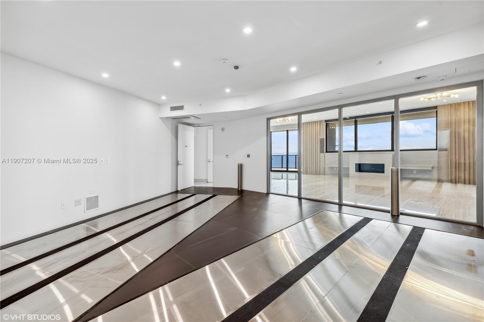 18555 Collins Avenue, Unit 1101 Sunny Isles Beach, FL 33160 - Photo 46 of 46 a view of an empty room with wooden floor and windows