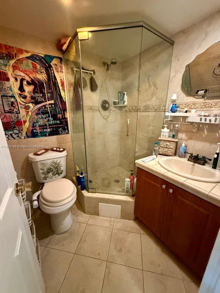 5401 Collins Avenue, Unit 131 Miami Beach, FL 33140 - Photo 14 of 33 a bathroom with a sink toilet and shower