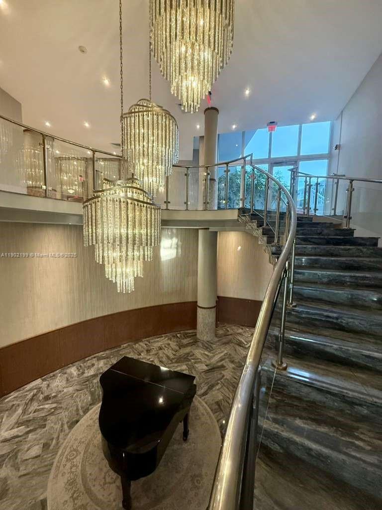 5401 Collins Avenue, Unit 131 Miami Beach, FL 33140 - Photo 17 of 33 a kitchen with kitchen island granite countertop a stove and a wooden floors
