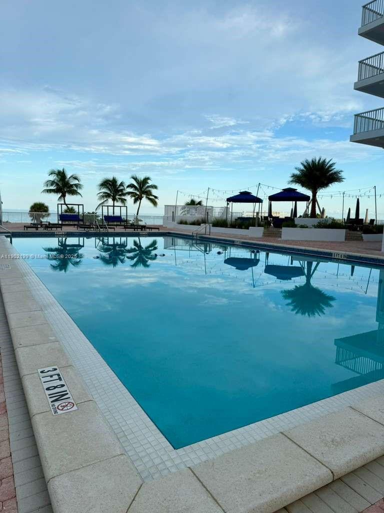 5401 Collins Avenue, Unit 131 Miami Beach, FL 33140 - Photo 21 of 33 a view of swimming pool with outdoor seating