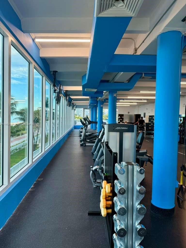 5401 Collins Avenue, Unit 131 Miami Beach, FL 33140 - Photo 26 of 33 a view of gym equipment with a view of living room