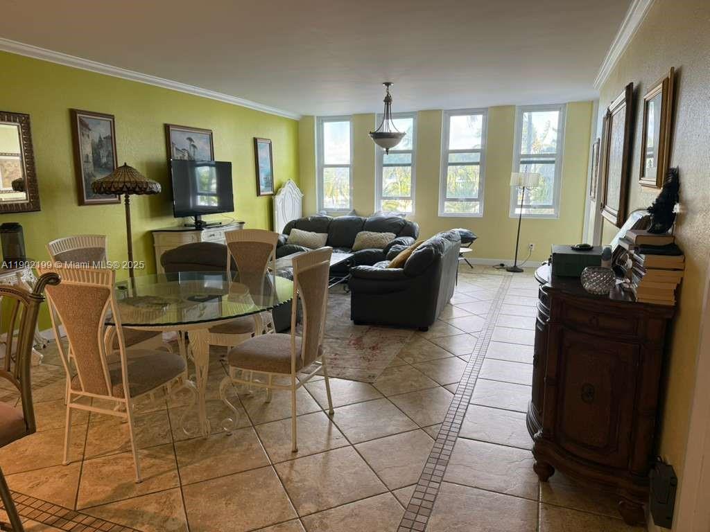 5401 Collins Avenue, Unit 131 Miami Beach, FL 33140 - Photo 7 of 33 a living room with furniture a flat screen tv and windows