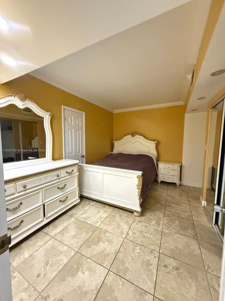 5401 Collins Avenue, Unit 131 Miami Beach, FL 33140 - Photo 9 of 33 a spacious bedroom with a bed and a view of bathroom