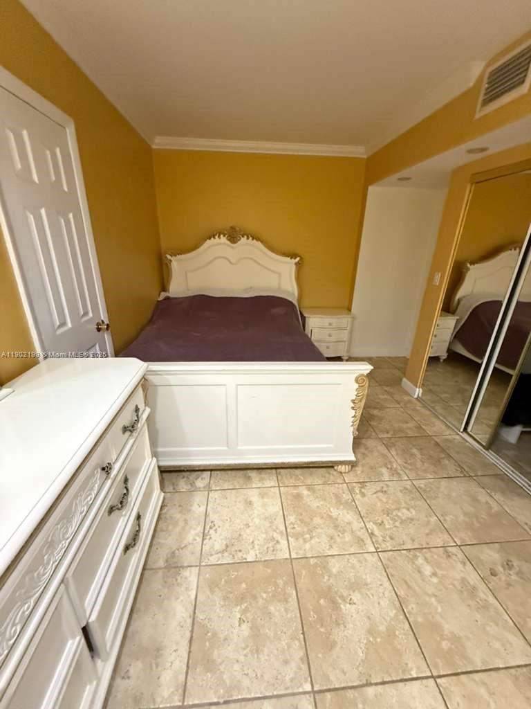 5401 Collins Avenue, Unit 131 Miami Beach, FL 33140 - Photo 10 of 33 a utility room with a sink a washer and dryer