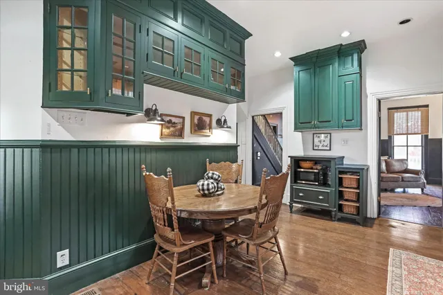 a kitchen with stainless steel appliances granite countertop a stove top oven and cabinets