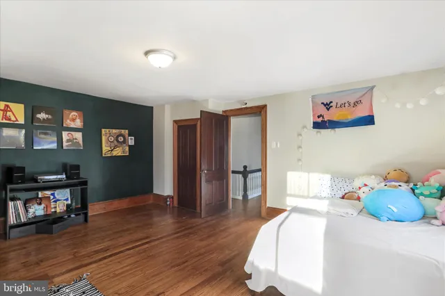 a living room with hardwood flooring and ceiling fan