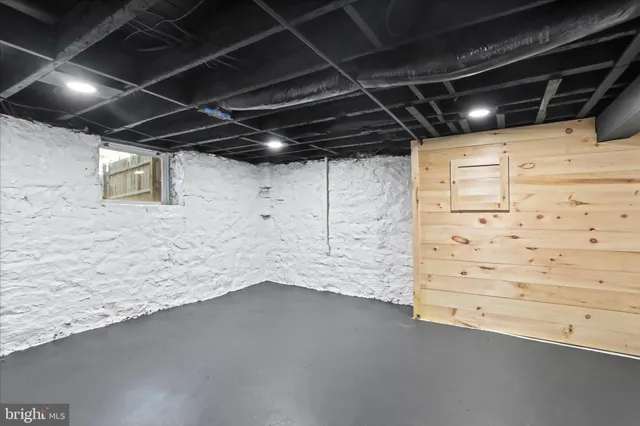 a aerial view of a house with swimming pool and large trees